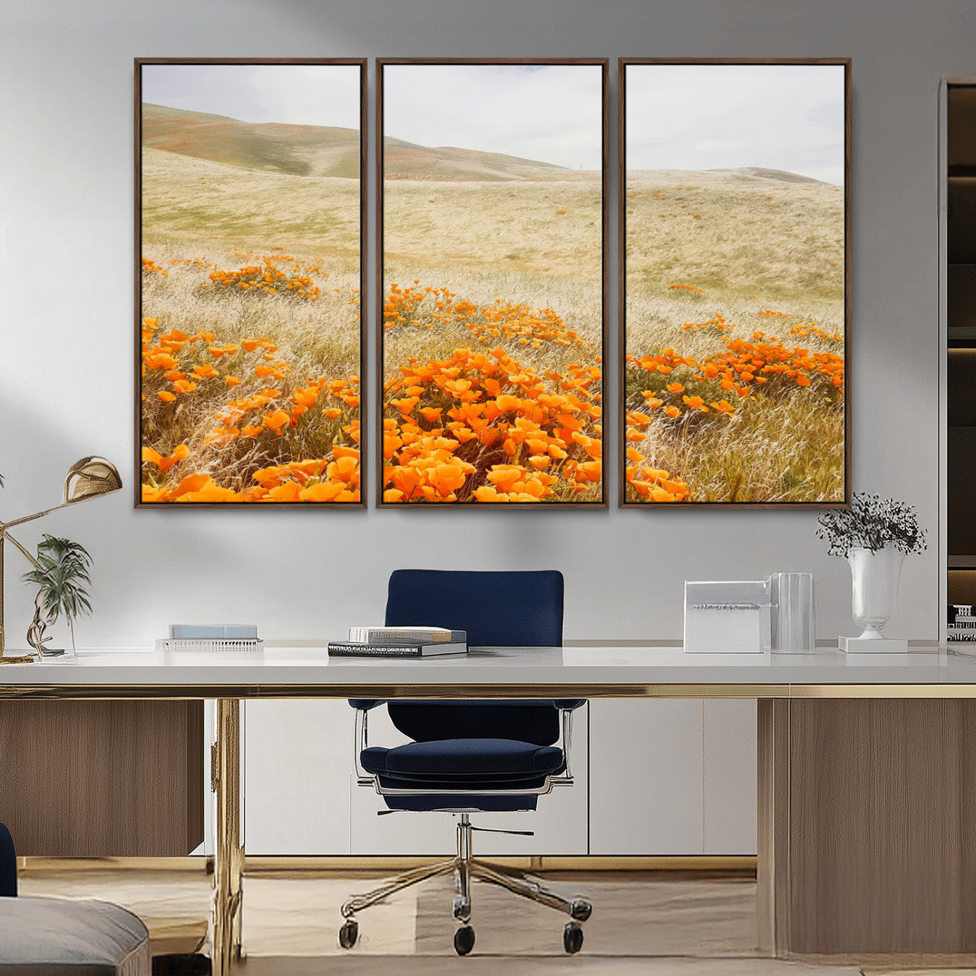 A golden field with vibrant orange poppies blooming across rolling hills under a soft, sunlit sky, creating a warm and rustic landscape.