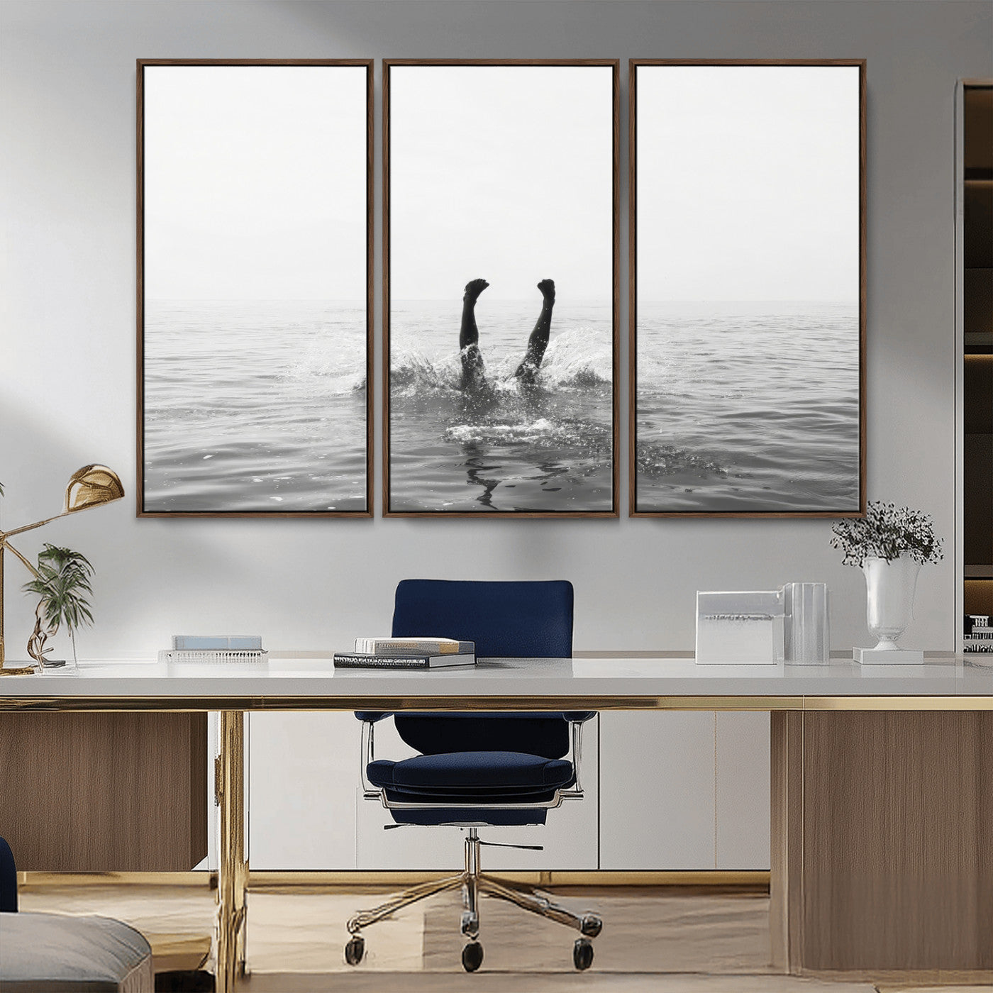 A black and white minimalist water scene capturing a playful splash as a swimmer dives upside down, creating a carefree and artistic aquatic aesthetic.