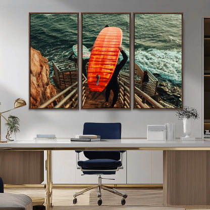 A surfer carrying a bold orange surfboard down a rugged staircase toward the ocean, bathed in golden hour light, capturing the energy of coastal adventure.