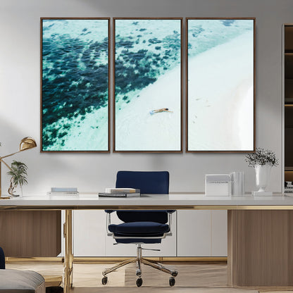 Canvas featuring an aerial view of a swimmer in shallow turquoise waters with coral patterns, ideal for tropical coastal home decor.