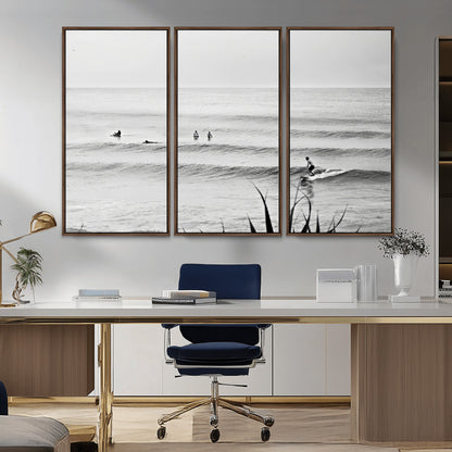 Monochrome canvas of surfers on calm ocean waves, ideal for minimalist coastal or beach-inspired interior decor.