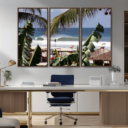 Canvas wall art of a tropical surf scene framed by palm trees, with a surfer on the shore and waves rolling in, ideal for beach-themed decor.