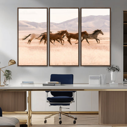 A herd of wild horses galloping through a sunlit desert plain with mountains in the background, perfect for rustic or western-themed wall decor.