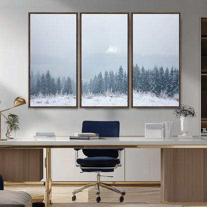 Snow-covered forest under misty sky, soft light breaking through clouds, ideal for minimalist or Nordic-inspired home decor.