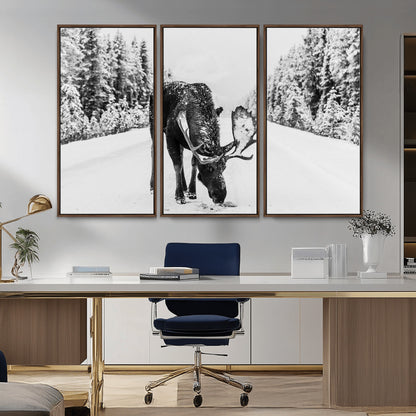 A majestic moose grazing in the snow-covered wilderness, surrounded by snow-covered trees, creating a peaceful winter scene.