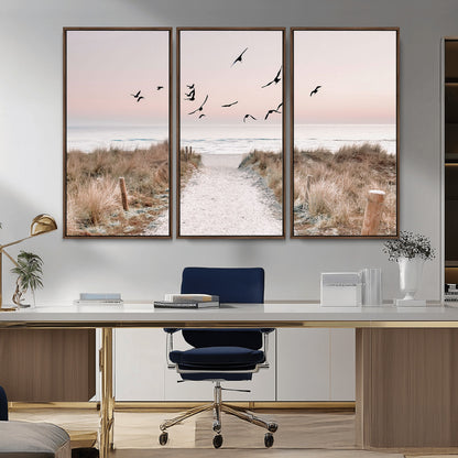 A peaceful coastal pathway leading to the ocean, with birds flying across a soft pastel sky, creating a calm and scenic beach atmosphere.