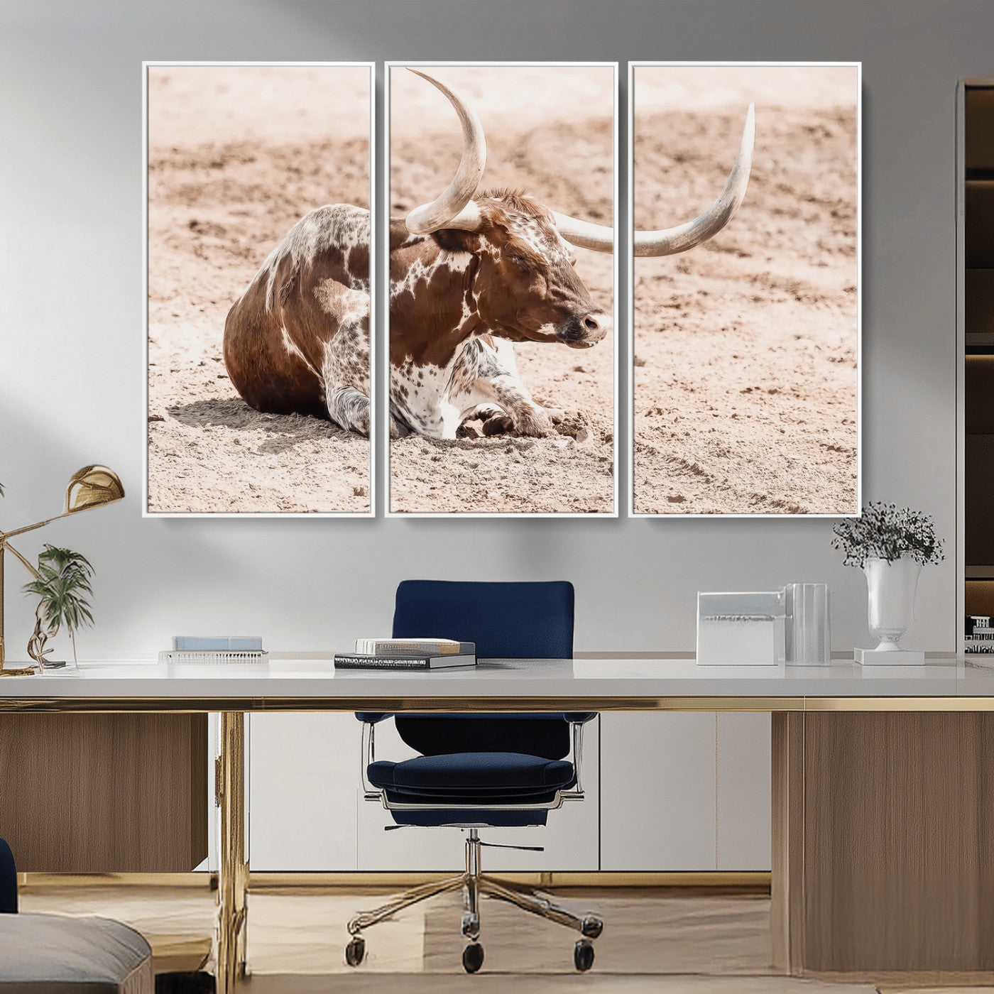 Texas Longhorn bull resting on dusty ground with warm tones, ideal for rustic western or farmhouse-themed wall decor.