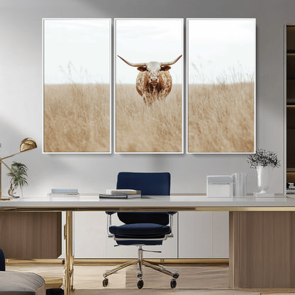 Texas Longhorn bull standing alone in dry grass with neutral tones, ideal for rustic western or cowboy-themed wall decor.