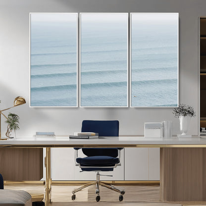Framed canvas of repeating ocean waves with a distant solo surfer, ideal for minimalist ocean or calm coastal wall decor.