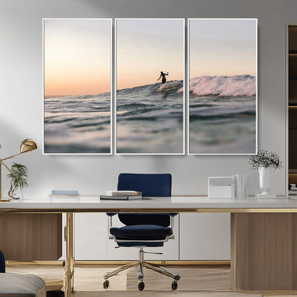 Framed canvas of a female surfer balancing on a wave at sunset, perfect for serene surf or ocean-inspired coastal decor.