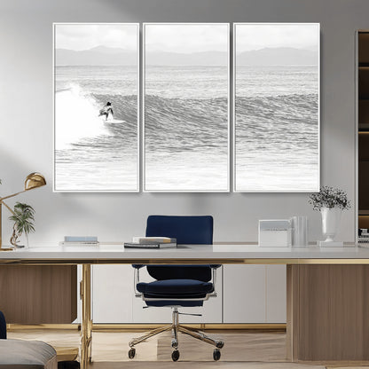 Monochrome photo of a surfer riding a wave with distant mountains, ideal for coastal motion or black and white surf-themed wall decor.