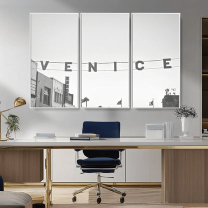 Black and white photo of Venice Beach sign and palm-lined street, perfect for urban coastal or minimalist LA-inspired wall decoration.