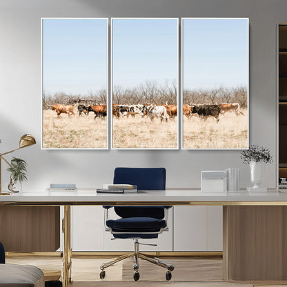 Framed wall art of Texas longhorn cattle walking through a dry, neutral-toned prairie, perfect for rustic farmhouse or western-themed home decor.