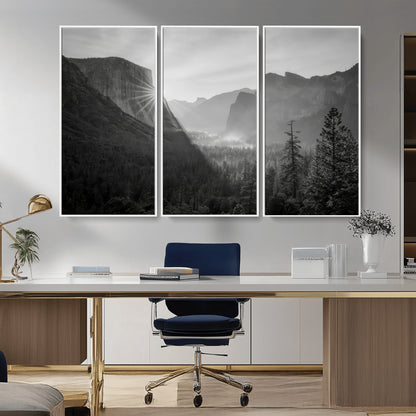 Black and white landscape of Yosemite with sun rays peeking over El Capitan, ideal for moody nature or modern rustic decor.