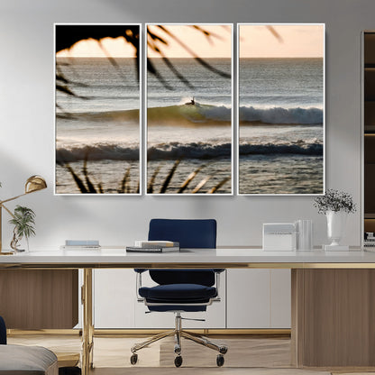 Photo of a surfer riding a golden hour wave at sunset, with tropical tones and dreamy light, perfect for tropical boho or coastal home decor.
