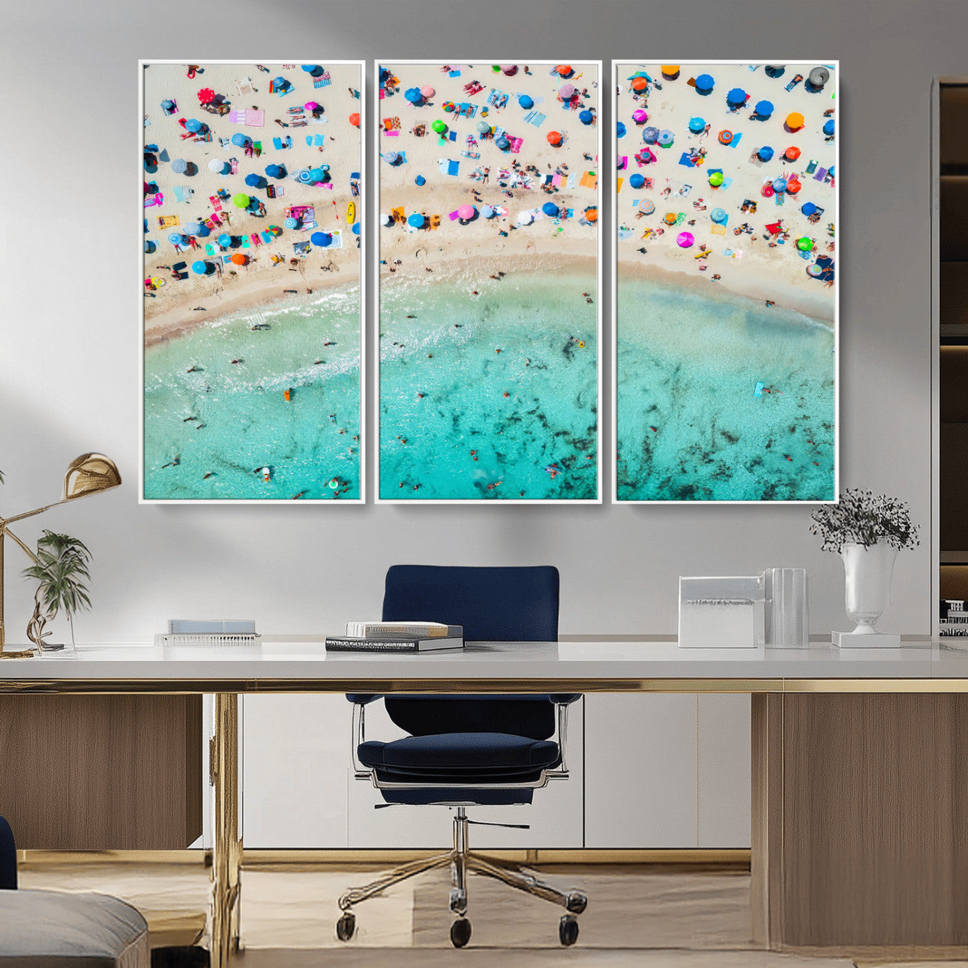 Aerial view of a vibrant beach filled with colorful umbrellas and people enjoying the turquoise ocean, capturing a lively summer vacation scene.