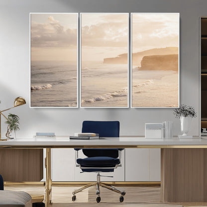 Golden hour seascape with misty cliffs and gentle waves rolling towards the shore, capturing a tranquil and warm coastal atmosphere.