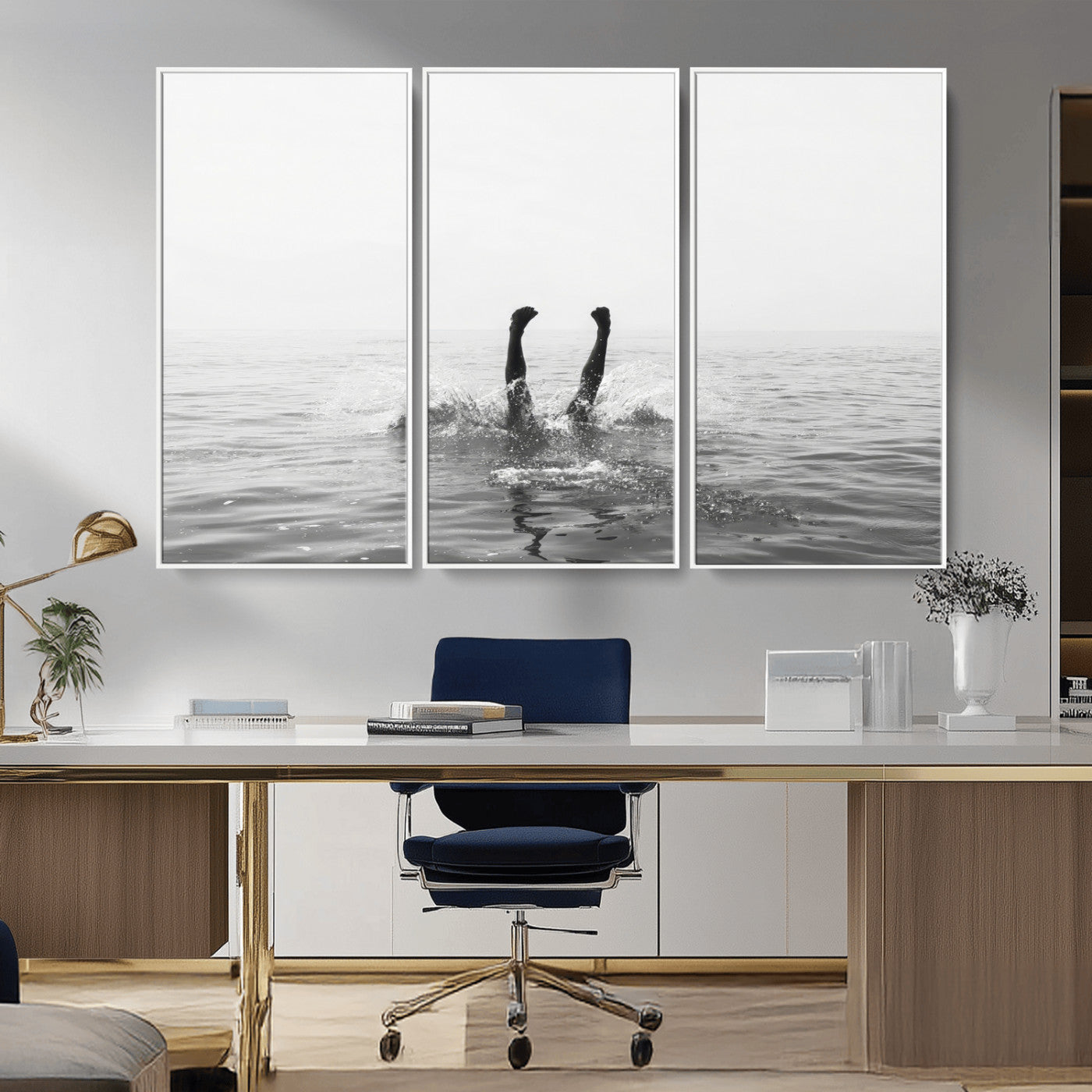 A black and white minimalist water scene capturing a playful splash as a swimmer dives upside down, creating a carefree and artistic aquatic aesthetic.