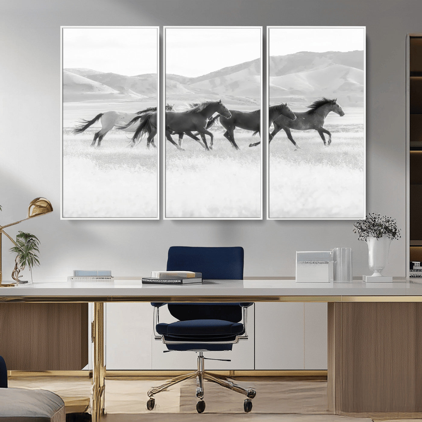 A black and white image of wild horses running freely across an open grassland, capturing the power and beauty of untamed nature in a rustic western setting.