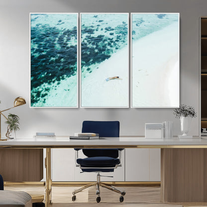 Canvas featuring an aerial view of a swimmer in shallow turquoise waters with coral patterns, ideal for tropical coastal home decor.