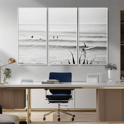 Monochrome canvas of surfers on calm ocean waves, ideal for minimalist coastal or beach-inspired interior decor.