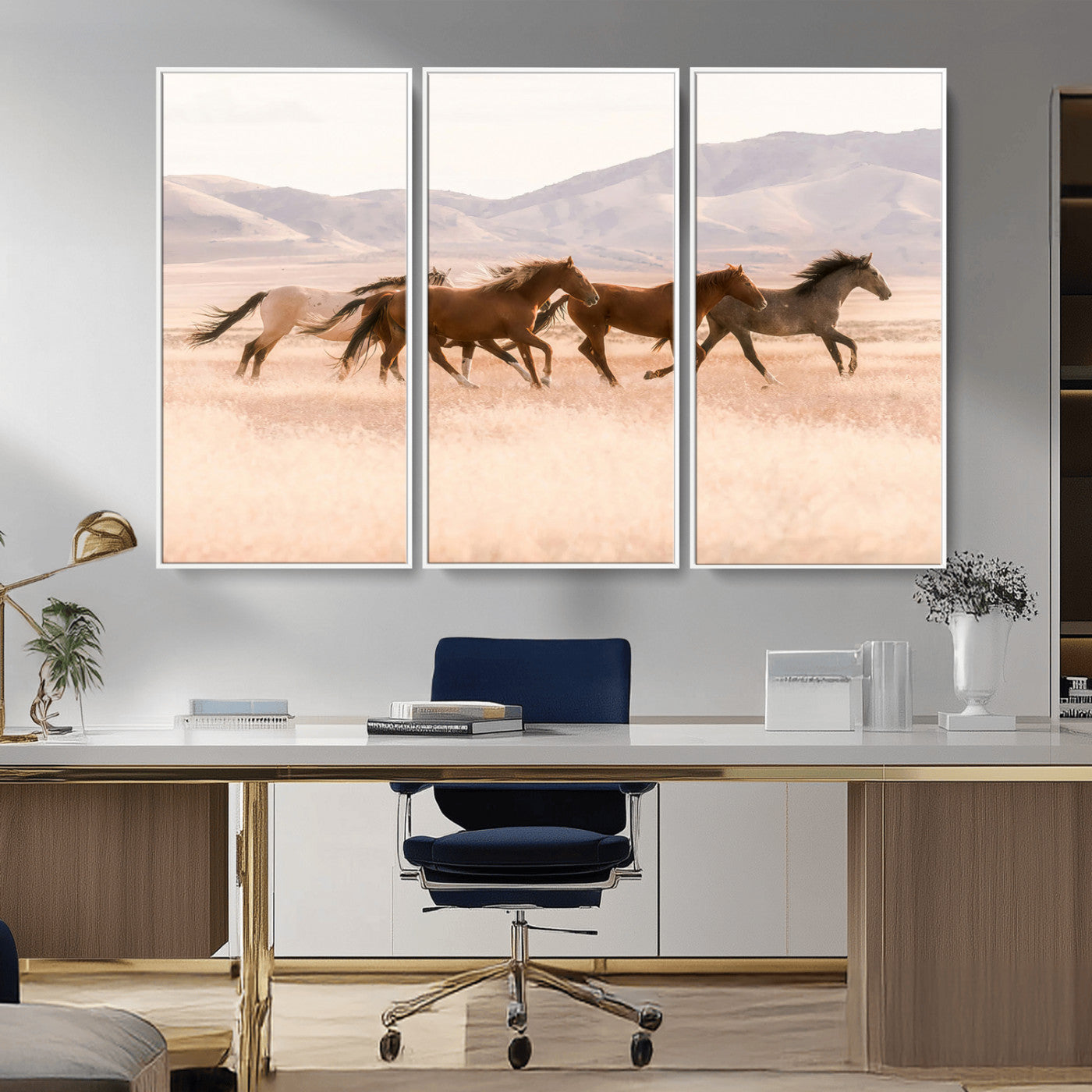 A herd of wild horses galloping through a sunlit desert plain with mountains in the background, perfect for rustic or western-themed wall decor.