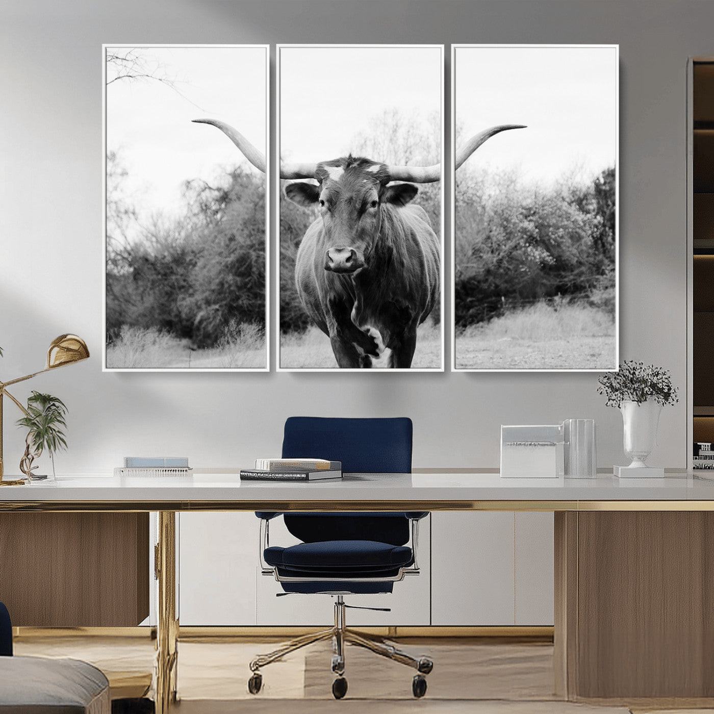Black and white photo of a longhorn cow in a field, perfect for rustic farmhouse or western-themed interior wall decoration.