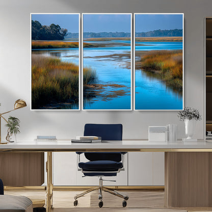 A peaceful marshland scene with calm blue water reflecting the surrounding grasses and trees, capturing the beauty of nature in a serene landscape.
