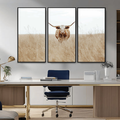 Texas Longhorn bull standing alone in dry grass with neutral tones, ideal for rustic western or cowboy-themed wall decor.