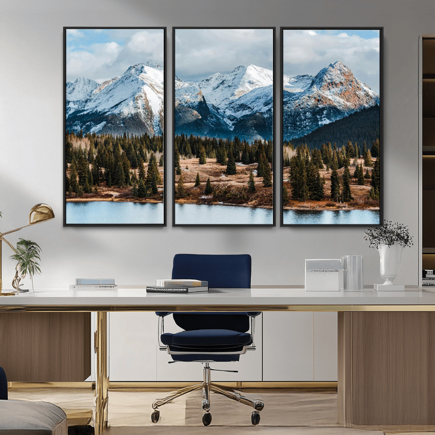 Framed canvas of snowy mountain peaks with pine forest and alpine lake, perfect for winter cabin or wilderness-inspired home decor.
