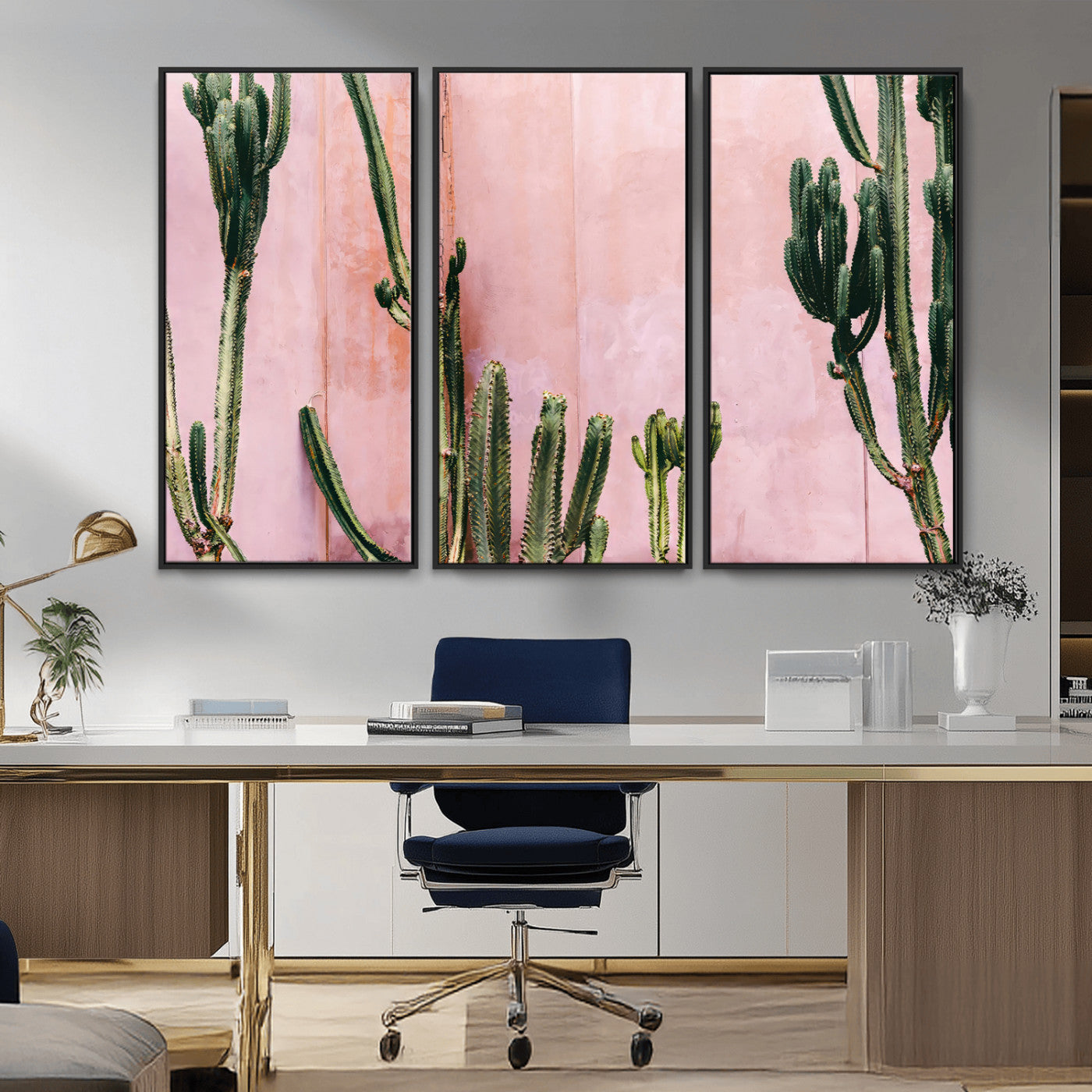 Framed canvas of tall green cacti against a soft pink wall, ideal for modern desert or colorful southwest-inspired home decor.