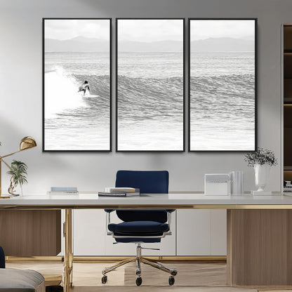 Monochrome photo of a surfer riding a wave with distant mountains, ideal for coastal motion or black and white surf-themed wall decor.