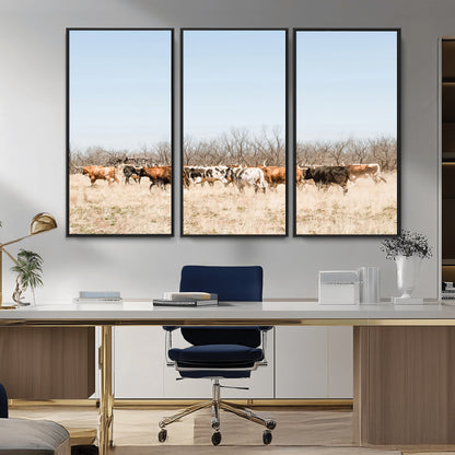 Framed wall art of Texas longhorn cattle walking through a dry, neutral-toned prairie, perfect for rustic farmhouse or western-themed home decor.