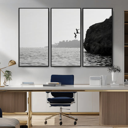 Black and white canvas of two figures cliff jumping into the sea, captured with moody tones, ideal for modern coastal or adventure-themed home decor.   2/2