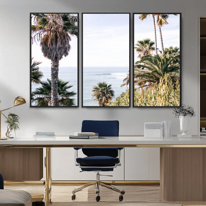 Scenic coastal view with tall palm trees overlooking a calm ocean, soft blue waves, and surfers in the distance, creating a peaceful tropical vibe.