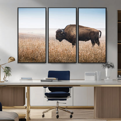 A majestic bison standing in an open prairie field, its strong form blending into the golden grass under a vast blue sky, evoking the wild spirit of the American plains.