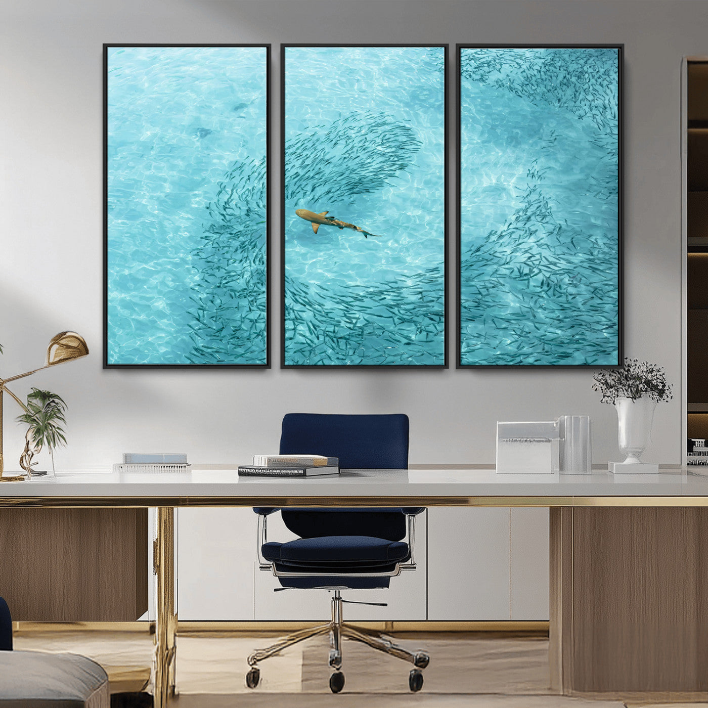 Aerial view of a shark swimming through a swirl of fish in clear turquoise waters, perfect for calm coastal or beach house decor.