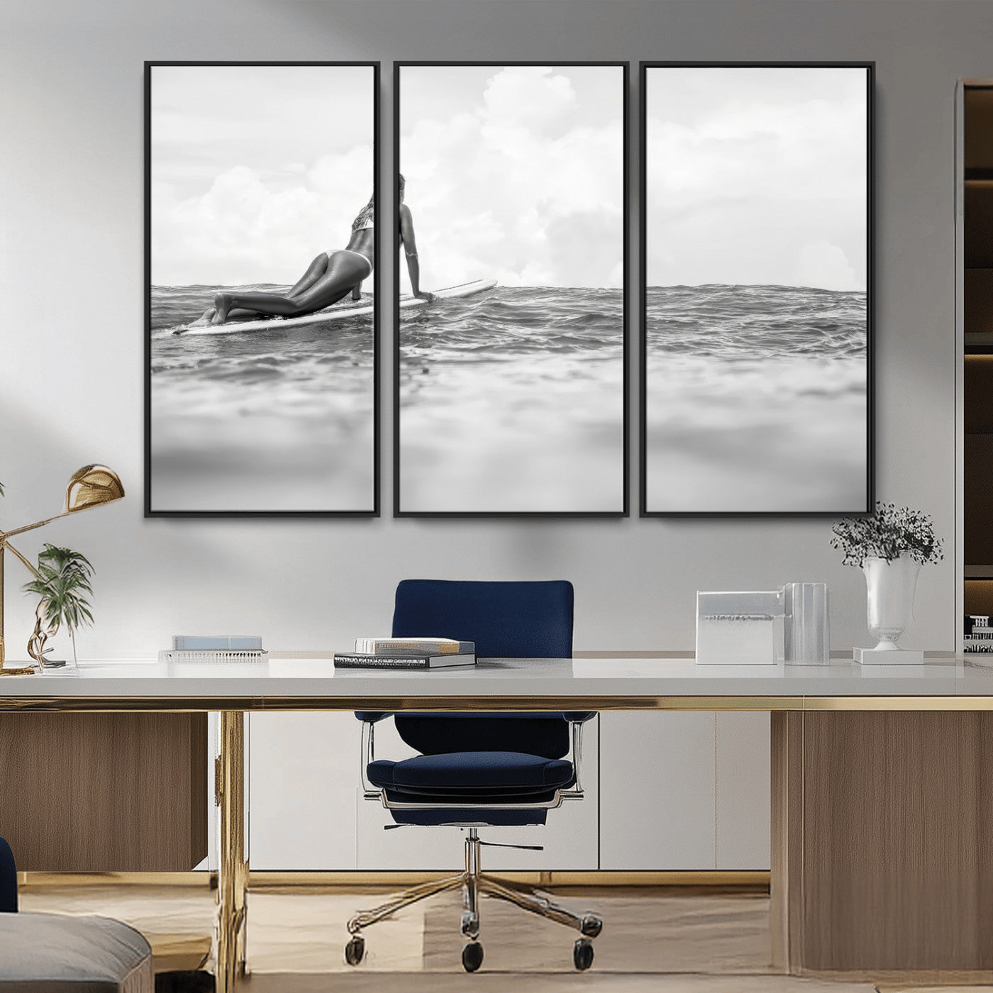 A black and white ocean scene featuring a surfer girl waiting on her board, gazing at the horizon, capturing a tranquil and adventurous coastal moment.