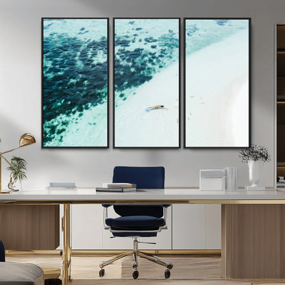 Canvas featuring an aerial view of a swimmer in shallow turquoise waters with coral patterns, ideal for tropical coastal home decor.