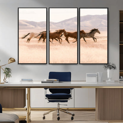 A herd of wild horses galloping through a sunlit desert plain with mountains in the background, perfect for rustic or western-themed wall decor.