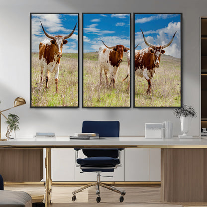 Three Texas longhorn cattle standing in dry grass under a bright blue sky, ideal for farmhouse or western rustic home decor.