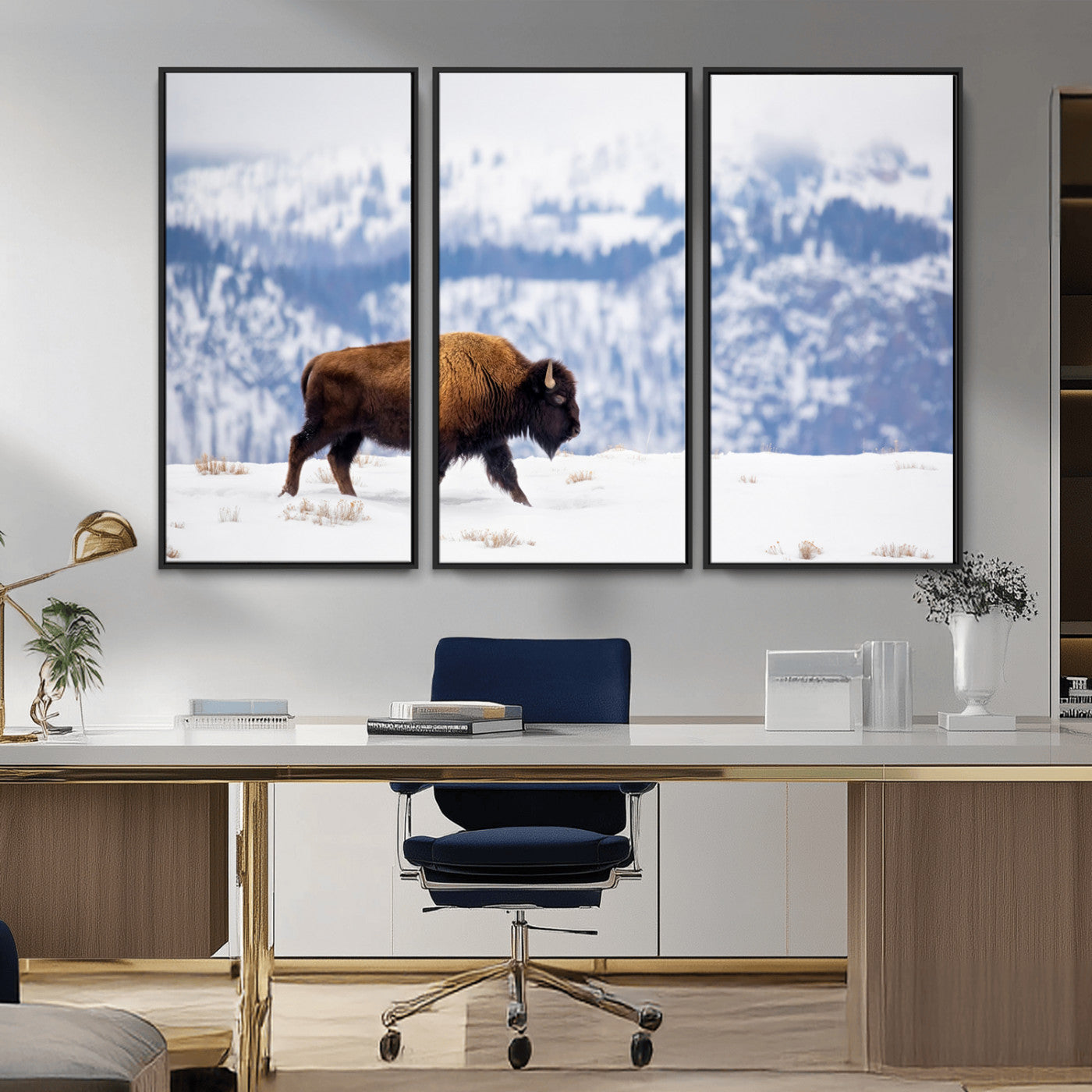 A lone bison walks across snowy ground with blue-toned mountain range behind, ideal for rustic or western farmhouse interiors.