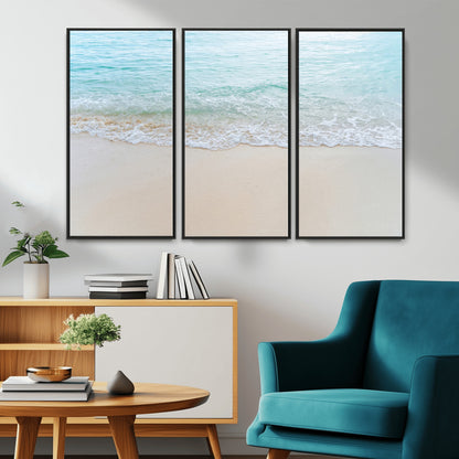 Soft shoreline with gentle aqua waves on smooth sand, ideal for minimalist coastal or pastel ocean-inspired home wall decor.