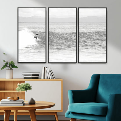 Monochrome photo of a surfer riding a wave with distant mountains, ideal for coastal motion or black and white surf-themed wall decor.