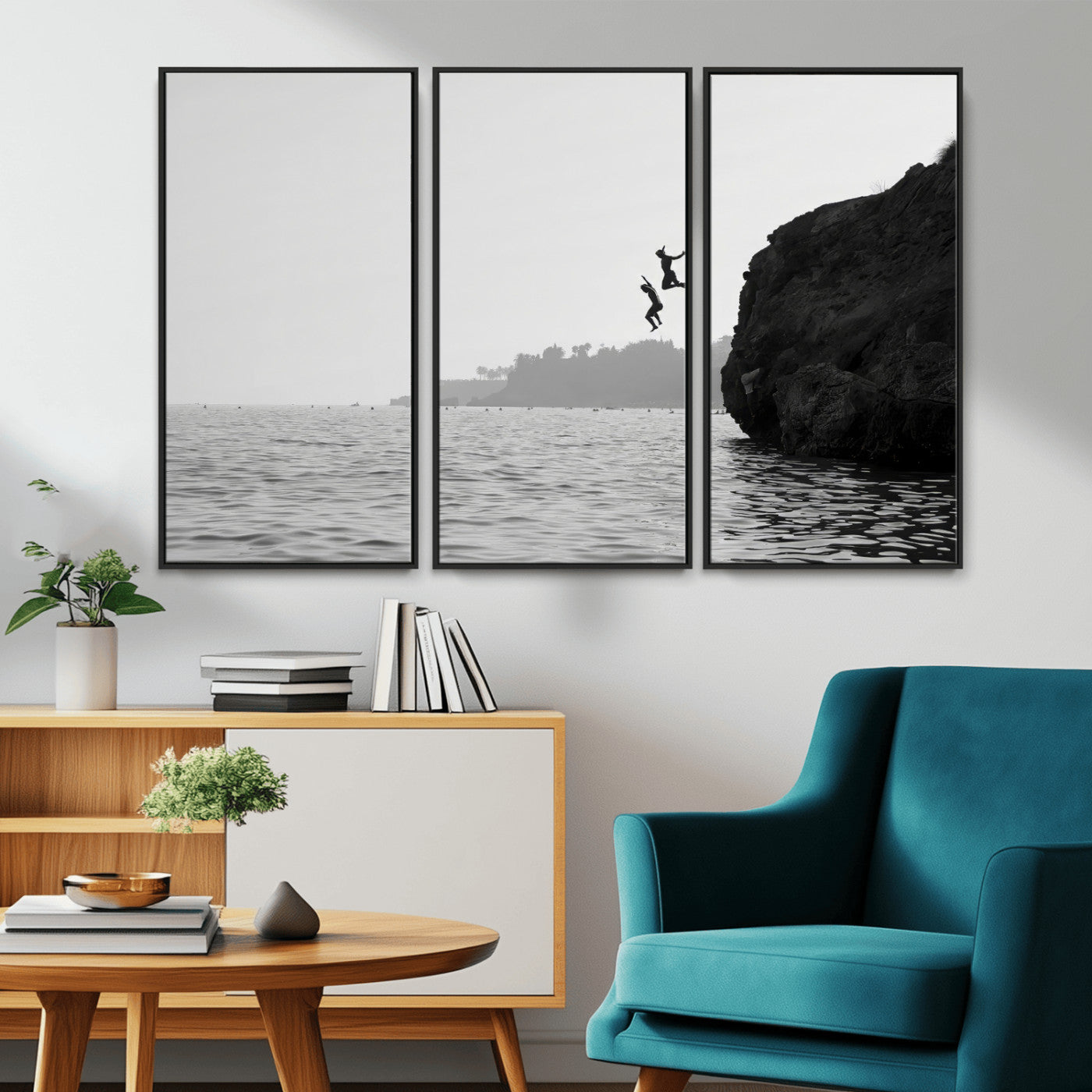 Black and white canvas of two figures cliff jumping into the sea, captured with moody tones, ideal for modern coastal or adventure-themed home decor.   2/2