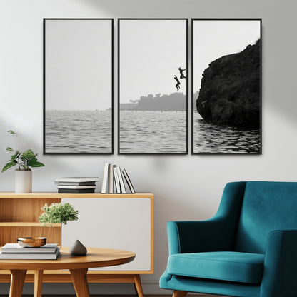 Black and white canvas of two figures cliff jumping into the sea, captured with moody tones, ideal for modern coastal or adventure-themed home decor.   2/2
