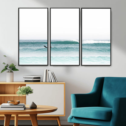 Minimalist photo of a lone surfer on calm aqua waves under bright sky, perfect for Scandinavian coastal or serene ocean-inspired home decor.
