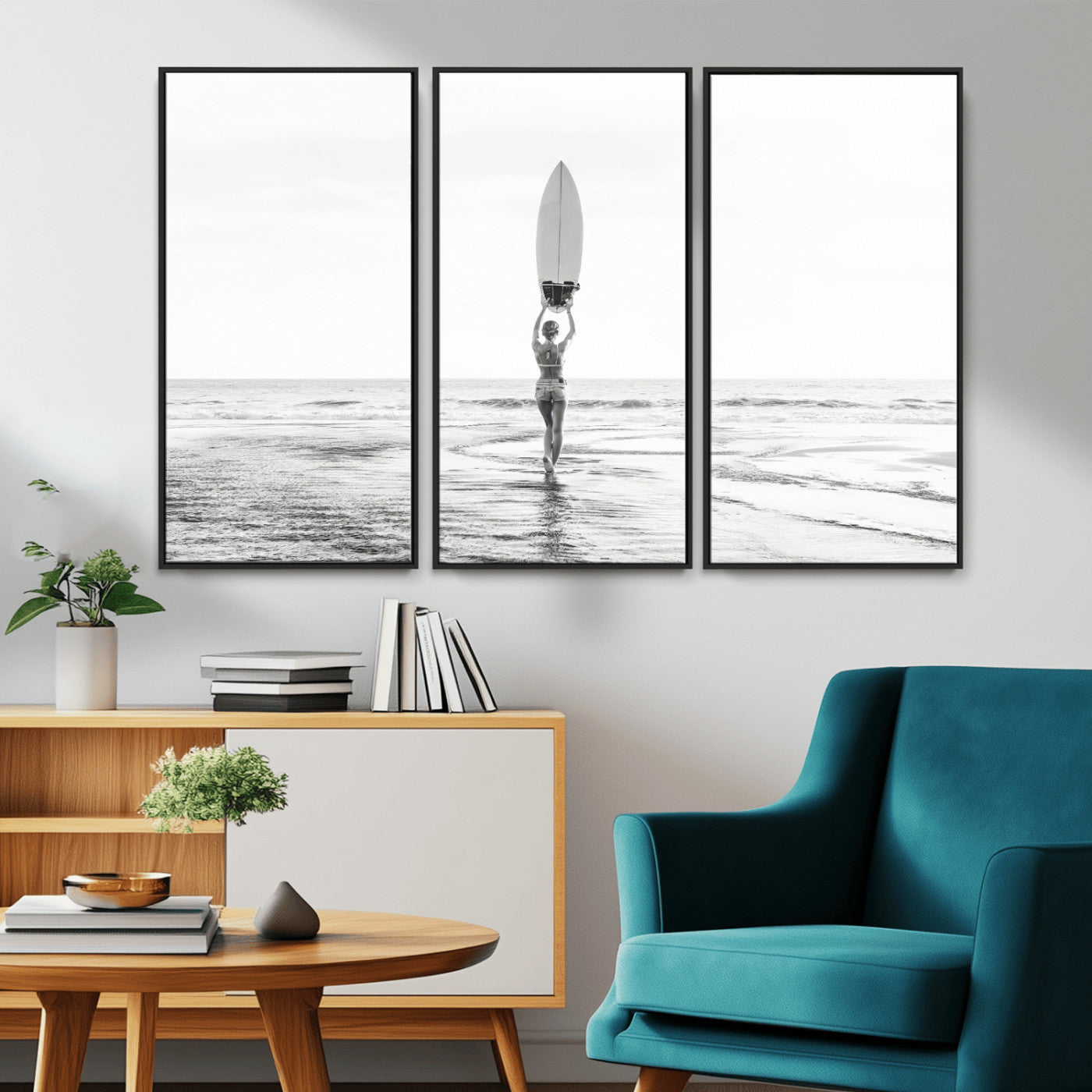 Black and white image of a female surfer holding a surfboard above her head while walking toward the ocean, creating a minimalist and bold coastal aesthetic.