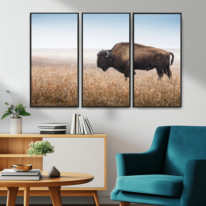A majestic bison standing in an open prairie field, its strong form blending into the golden grass under a vast blue sky, evoking the wild spirit of the American plains.