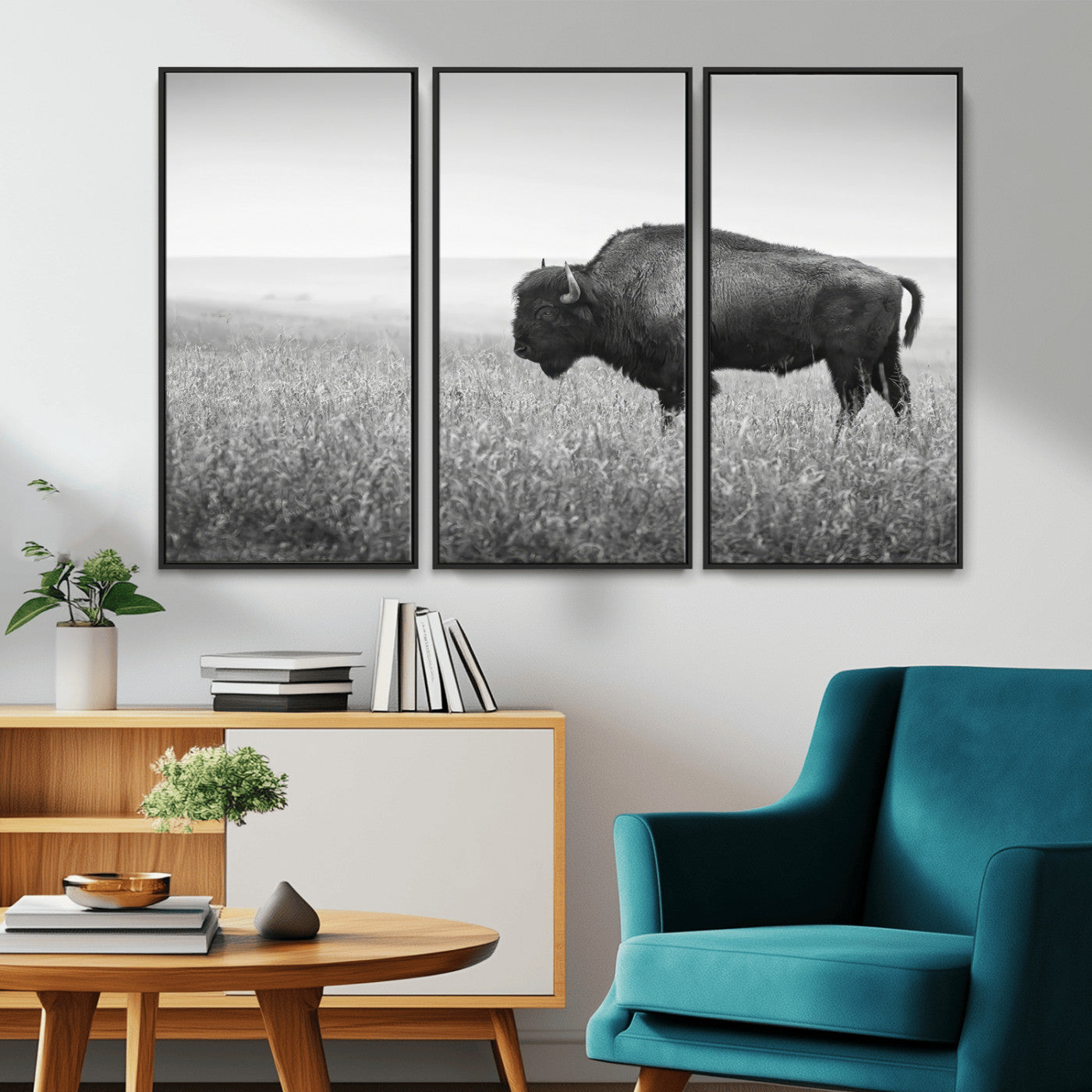 A black and white photograph of a majestic bison standing in a vast grassy prairie, evoking a sense of wilderness and strength.